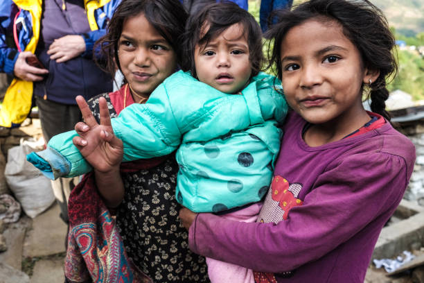 Pokhara, Nepal - November 28, 2016: Group of children holding a baby in Nepal.