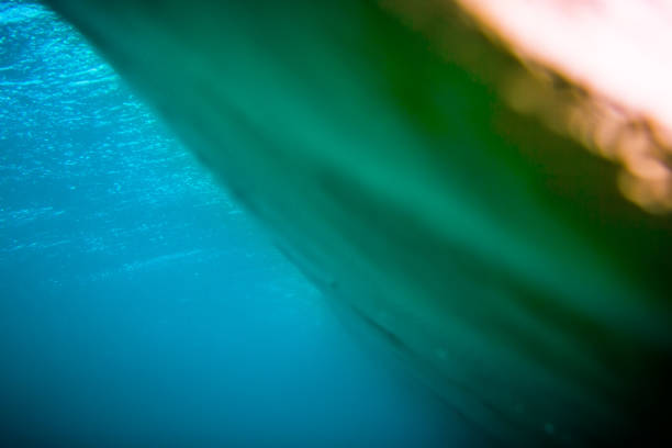 istock Blue wave underwater in ocean and sunset colors. Clear barrel wave 801239164