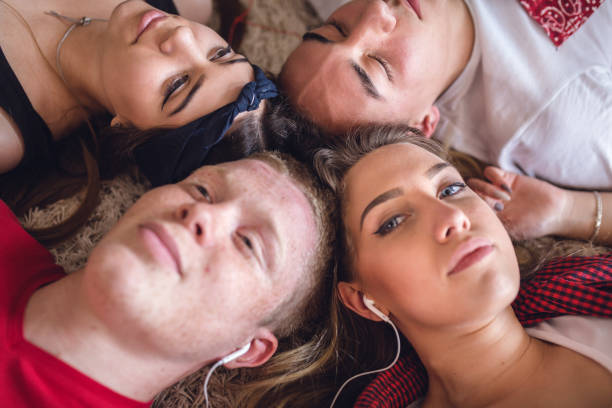 music time - couple loving lying on back carpet imagens e fotografias de stock