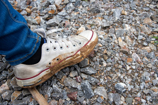 istock sneakers dirty on mud, life style concept. 801258202