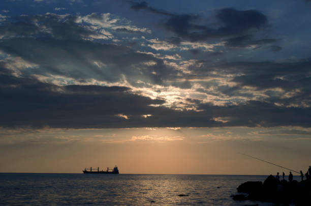 The ship that is laying a gas pipe on the sea bottom against the sunset