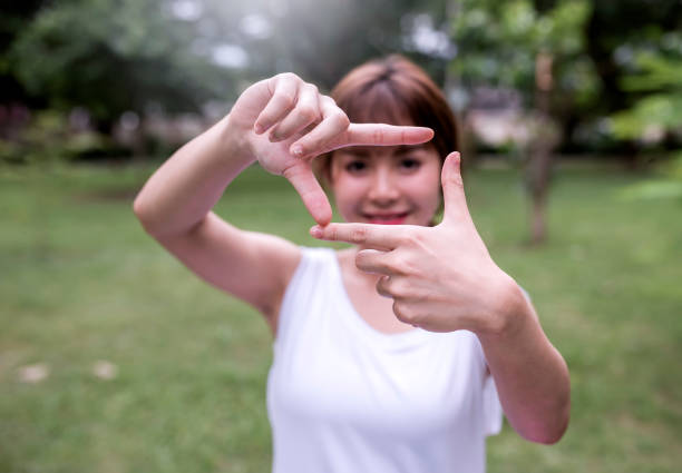 istock Pretty girl having fun outdoor ,making frame with her hands 801269906