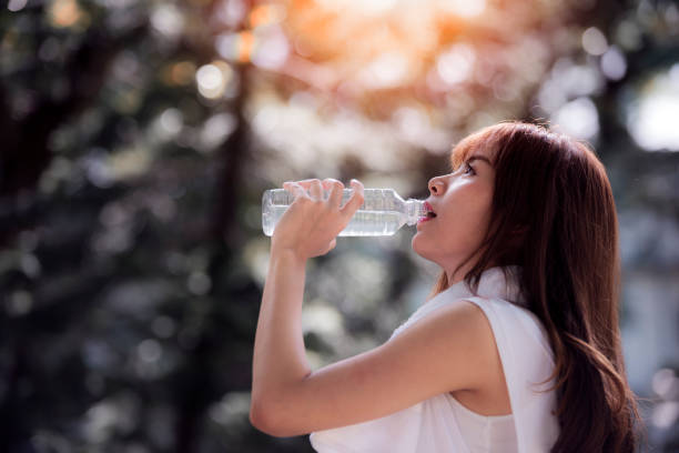 istock Young girl drinking water during morning jogging 801270784