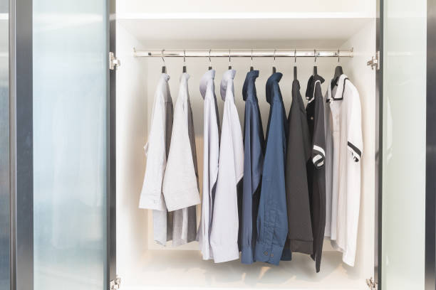 istock clothes hanging on rail in wooden white wardrobe 801273670