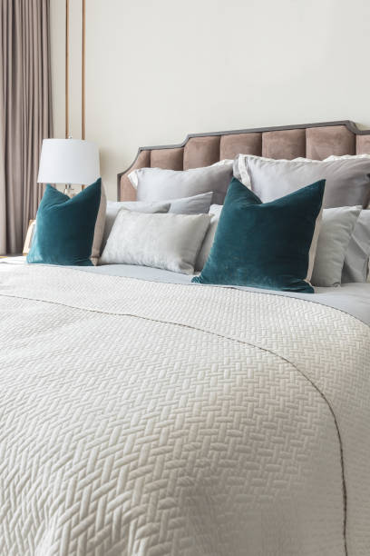istock classic bedroom style with set of pillows and lamp on table side 801273694