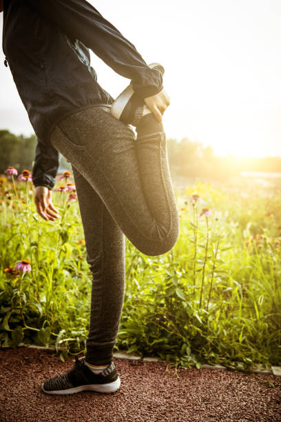 woman stretching legs - railing beautiful human leg people imagens e fotografias de stock