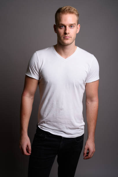 istock Studio shot of young muscular handsome man against gray background 801289926