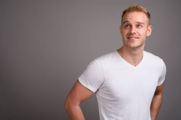 istock Studio shot of young muscular handsome man against gray background 801290404