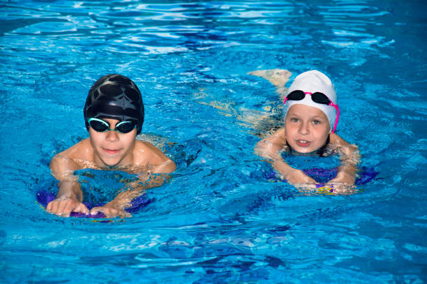 istock Little children swim in the poo 801297432