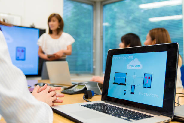 Close-Up Of Laptop On Table Against Blue Background