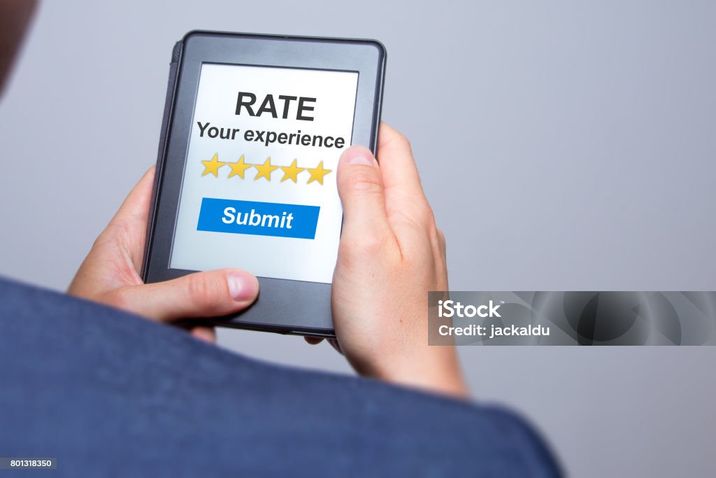 Businessman hands holding tablet with Rate your experience. Business concept. Stock photo Luxury Hotel Stock Photo