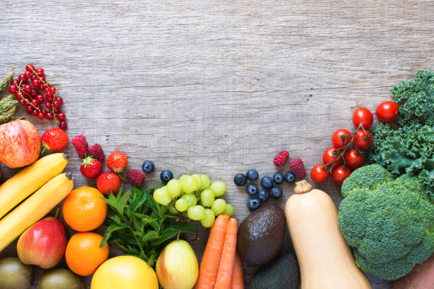 istock Different fruits and vegetables on wooden table 801318596