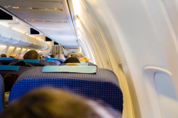 istock Interior of passenger airplane with people on seats 801318776