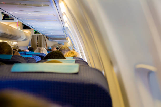istock Interior of passenger airplane with people on seats 801319050