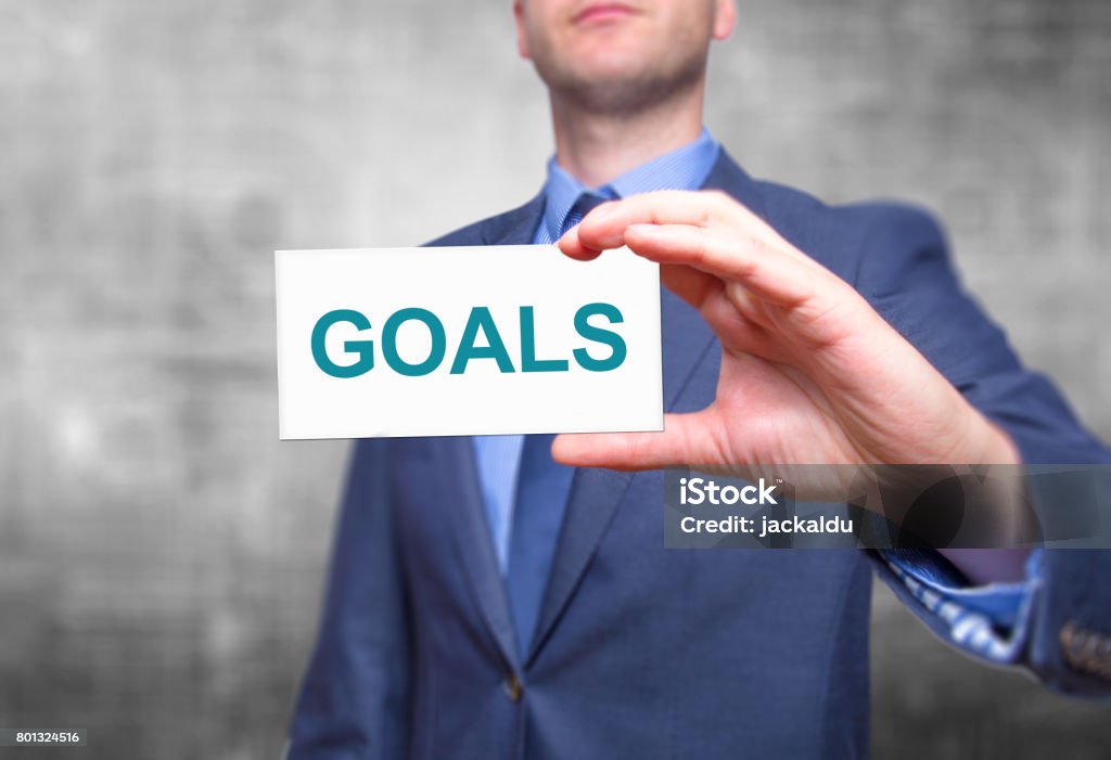 Goals text with businessman holding a sign. Business concept. Stock Photo Achievement Stock Photo