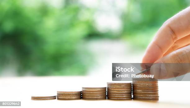 Close Up Of Female Hand Stacking Coins Stock Photo - Download Image Now - Abundance, Backgrounds, Banking