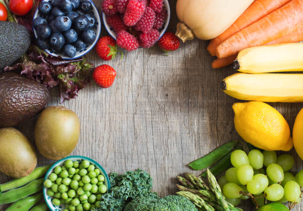 istock Different fruits and vegetables on wooden table 801329942
