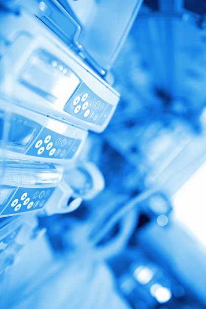 Close up of doctor operating medical equipment in hospital.