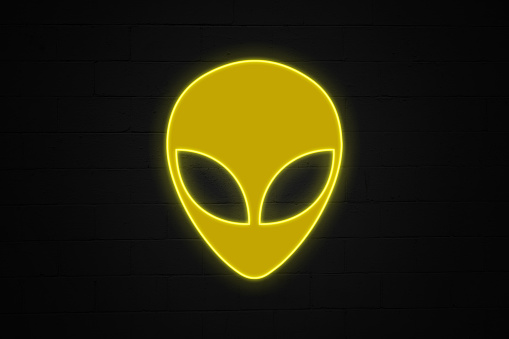 Neon light shaped into an alien face.