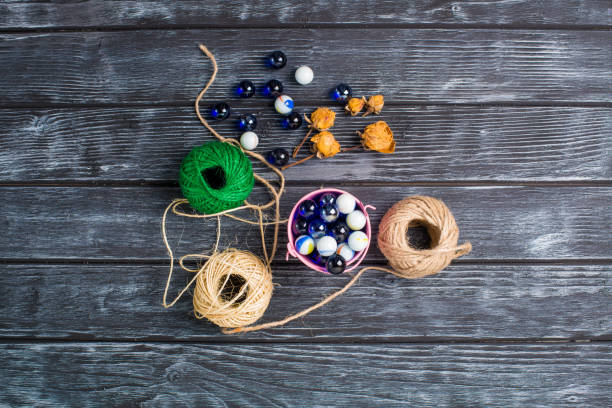 istock ball of threads on wooden background 801344586