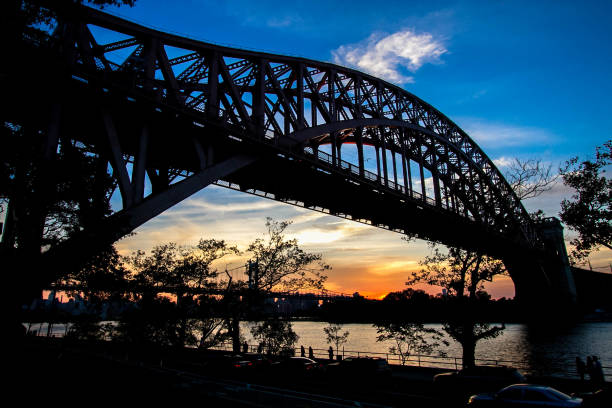 istock Hell Gate Bridge and in silhouette with sunset sky, New York 801346948