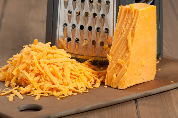 grated red leicester cheese. grater. cooking ingredient. - recipe ingredient grater cheese grater imagens e fotografias de stock