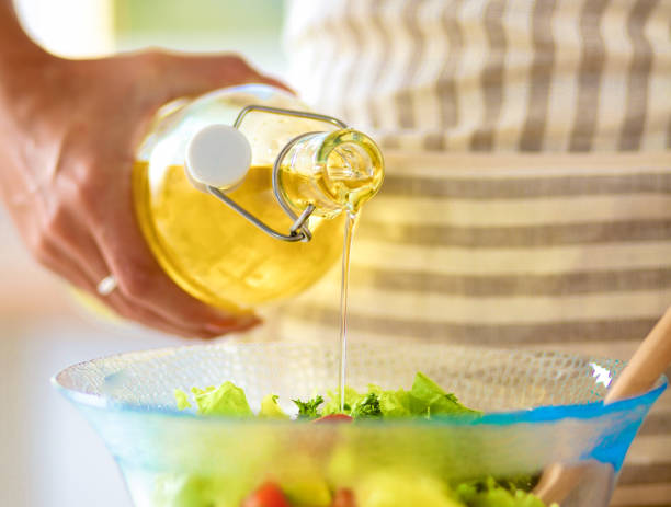 istock Young woman mixing fresh salad 801359218