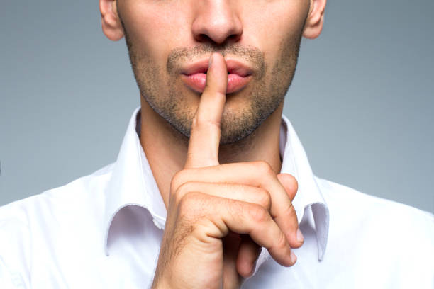istock Businessman silent quiet gesture with finger 801363942