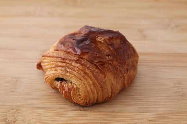 istock french bread pain au chocolat chocolate croissant on wood table 801375498