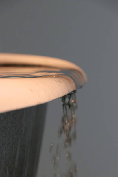 istock water spilling over a bathtub 801377750