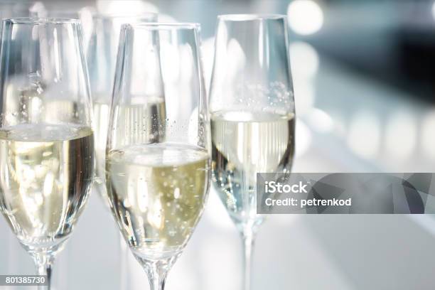 Champagne Glasses On White Background In Bright Lights Stock Photo - Download Image Now
