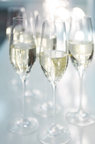 istock Champagne glasses on white background in bright lights 801385822