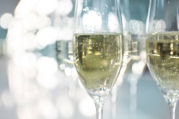 istock Champagne glasses on white background in bright lights 801385858