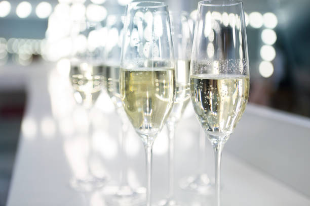 istock Champagne glasses on white background in bright lights 801386314