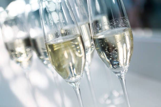 istock Champagne glasses on white background in bright lights 801386326