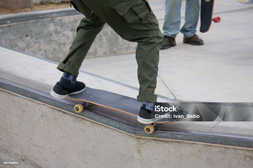 Skateboarder grinding a rail at Venice Skate Park Skateboarding at Venice Skate Park at Venice Beach, Los Angeles California Beach Stock Photo