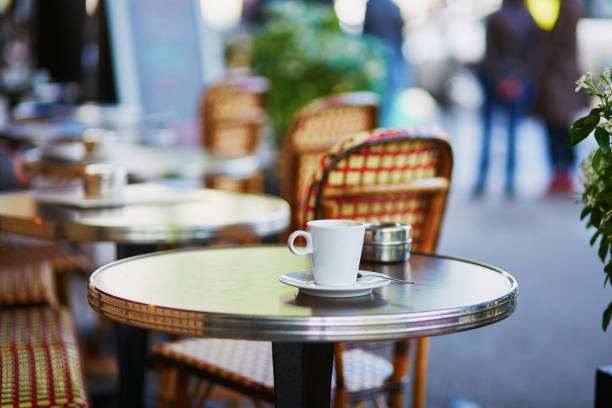 istock Coffee cup on a table of typical Parisian cafe 801392050