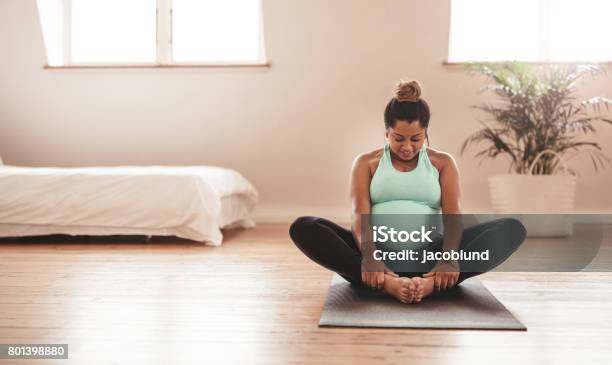 Beautiful Expectant Mother Doing Yoga At Home Stock Photo - Download Image Now - Pregnant, Exercising, Women