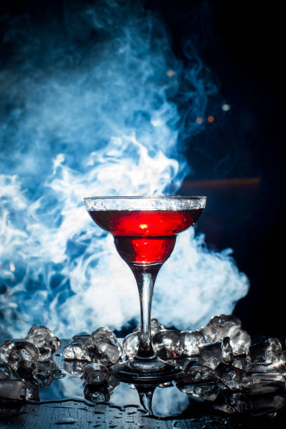 istock red cocktail with ice vapor, blue background 801433030