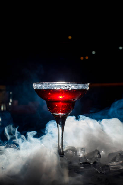 istock red cocktail with ice vapor, blue background 801435108