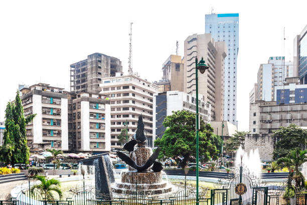 Stock photo of Place du Coq (Rooster Square) with a monument dedicated to the heroes of the First World War 1914-1918, toped with the Gallic rooster, in downtown Cayenne, the capital city of French Guiana, South America. The Gallic rooster is a symbol of historic French roots.