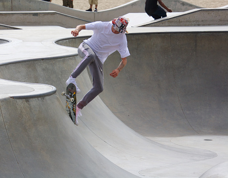 Venice, California - May 24, 2017: Unidentified skateboarder doing tricks while skateboarding at Venice Skate Park in Venice Beach California.