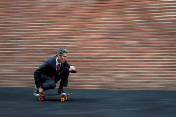 Motion blurred businessman skateboarding
