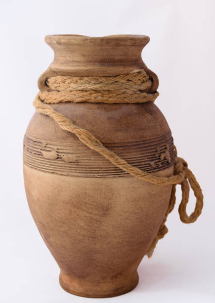 istock Clay jug with rope on white background 801537190