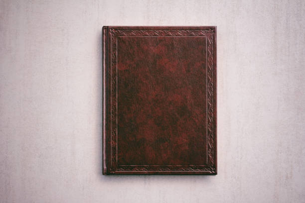 the book in a red cover on a light gray background, top view the book in a red cover on a light gray background, top view old book stock pictures, royalty-free photos & images