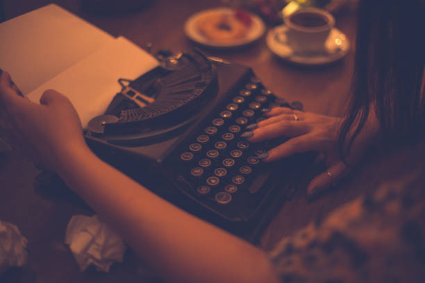 istock Woman working on retro typewriter at desk 801551456