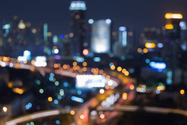 istock Night blurred bokeh light city and highway overpass aerial view 801559362