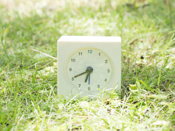 istock White simple clock on lawn yard, 6:40 six forty o'clock 801560988