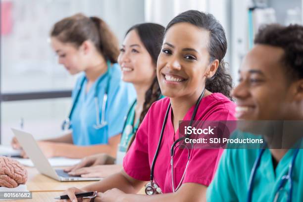 Medical Student Smiles At Camera In Class Stock Photo - Download Image Now - Nurse, Learning, Classroom