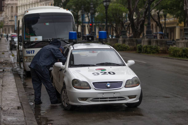 Havana, Cuba - January 29, 2017: Police car on the road side and the police on the left side.